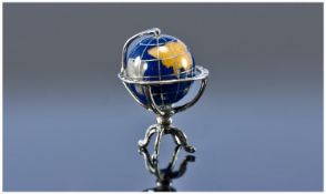 An Unusual Silver And Enamel Miniature Globe. The globe revolves. Marked 925 and with Italian