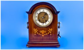 Edwardian Inlaid Mahogany Mantel Clock. 8 day striking on a gong. The dial with porcelain chapter