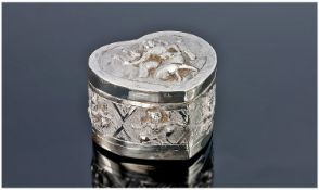 A Heart Shaped Oriental Silver Box. The hinged lid and sides boldly decorated with deities to a