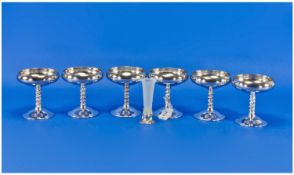 Set Of Six Plated Ice Cream Dishes On Elaborate Stems. With a small plated epern with glass flute.