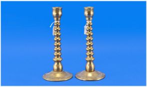 Pair of 20th Century Brass Candlesticks, the columns of bobbin turned design, 9 inches high.