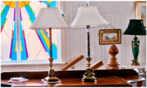 Pair of Painted Tole Work Lamps, with a painted black column supported by a brass pineapple finish.