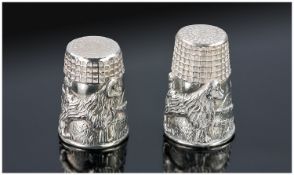 Two Silver Thimbles (one slightly larger than the other one). Each with raised design of a poodle