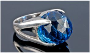 Silver Ring Set With A Large Blue Faceted Stone.
