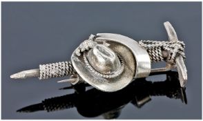 An Unusual Silver Mountaineers Brooch Designed as a Conjoined Ice Axe Rope and Hat with a vacant