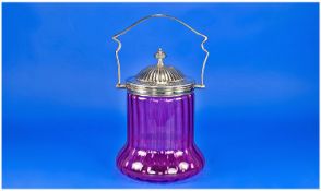 A Early 20th Century Cranberry Glass Swing Handle Biscuit Barrel with silver plated swing handle