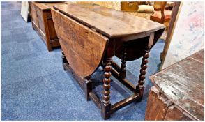 Late 17th Century Oak Gate-Leg Table, of two-leaf form, the top raised on bobbin turned legs,