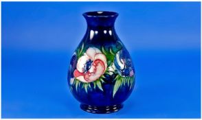 William Moorcroft Signed Vase `Anemone` Design On Blue Ground. 7 inches high.