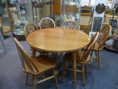 Modern Oak Veneered Dining Table, of circular form, raised on beech legs, together with a set of