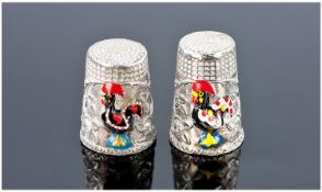 A Pair of Silver and Enamel Thimbles. Each featuring a raised and enamelled cockerel. Unmarked but