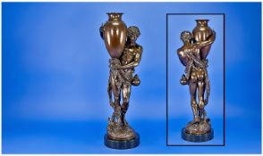 A Classical Bronzed Figure After The Antique Of A Semi Naked Youth Carrying A Greek Vase,