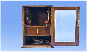 Edwardian Oak Smokers Cabinet. Complete with fitted interior and draw. The front door with glass
