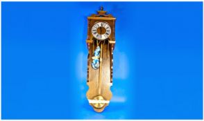 Oak Cased Bracket Style Wall Clock with three brass weights and brass style chapter ring; 41 inches