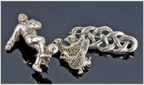 Three Silver Brooches, In the Form Of A Footballer, Celtic Knot And Group of Ducks.