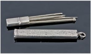 An Edwardian Silver Needle Case. The body with foliate decoration vacant cartouche and pull-off