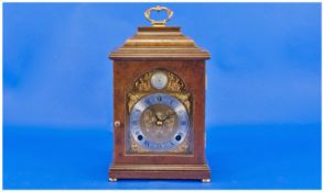 A Brass Arched Faced English Bracket Clock By Elliot Of Croydon, of small size. In a walnut case