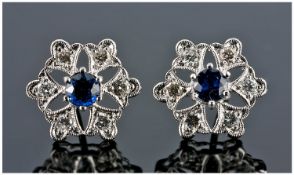 18ct White Gold Diamond And Sapphire Stud Earrings, In The Form Of A Flower Head With Central