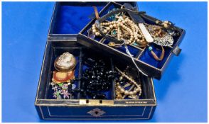 Black Jewellery Box Containing A Small Quantity Of Costume Jewellery, Beads, Brooches etc.