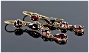Pair Of Closed Back Garnet Drop Earrings Each Set With Alternating Round And Pear Shaped Stones,