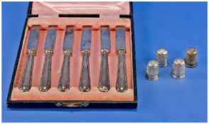 A Boxed Set of Silver Handle Fruit Knives. Hallmarked Sheffield 1917, plus 4 silver thimbles,