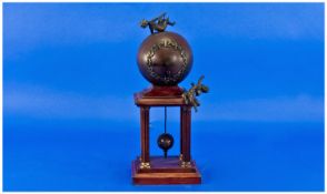 Mahogany Pedestal Globe Mantle Clock. With cherub decoration. Ball pendulum probably French 1900.