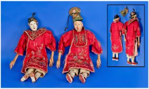 Chinese Antique Doll Figures. A pair of wood bodies figures of a Mandarin and his wife dressed in