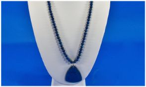 Lapis Lazuli Pendant Necklace, a triangular, solid piece of lapis, held by a sterling silver bale,