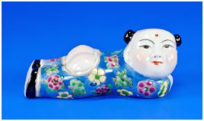 Interesting Small Chinese Sleeping Figure, depicting a smiling child outstretched in coloured blue