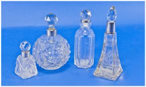 Four Silver Rimmed Cut Glass Perfume Bottles, with stoppers. Various shapes and sizes.