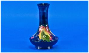 Moorcroft Vase ``Leaves and Berries`` on blue ground. Signed to base. 6 inches high.