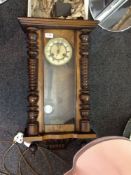 Vienna Type Wall Clock. Stained walnut veneered case with two turned side columns to the side. The