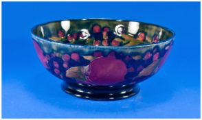 Moorcroft `Pomegranate and Berries` Pattern Bowl, on a deep blue ground, rising from the footed