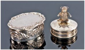 Silver Hinged Pill Box Surmounted By A Teddy Bear. Together With An Oval Shaped Hinged Pill Box.