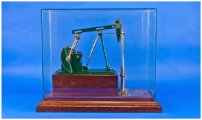 A Stuart Turner Oil Field Pump. Non runner, model only in a glass case. Overall height 15 inches.