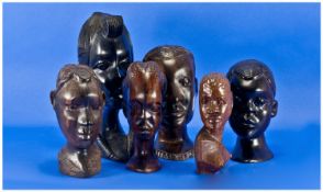 Six Carved African Heads, all hardwoods, finely carved details to the faces. 3 carved heads of men