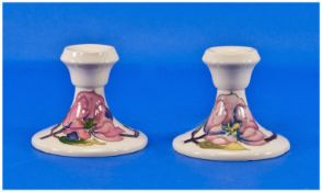 Moorcroft Pair Of Squat Candlesticks `Pink Magnolia` Design, on cream ground. Each 3.25 inches