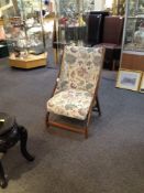 Victorian Nursing Chair, with cross over style back in stained beech wood. Covered in a floral