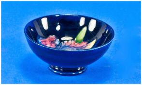 Moorcroft Small Footed Bowl `Orchids` Design, on blue ground. Label to base reads `Potters to Late