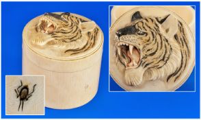 A Finely Carved Ivory Japanese Round Lidded Box, carved to the lid with a roaring tiger, of fine