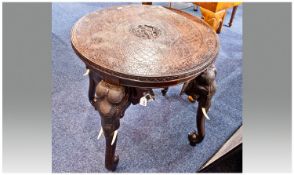 Indian/Burmese Carved Teak Round Low Table. The top profusely carved with floral decoration. The