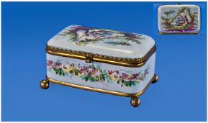French Porcelain Lidded Trinket Box, Brass mounted on ball feet, painted panel to the top depicting