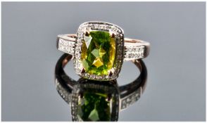 A Good Quality 14ct Rose Gold Set Peridot & Diamond Ring. The single stone peridot of approx 3.2cts