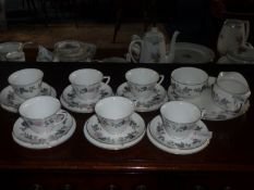 Royal Worcester `June Garland` Tea Set, comprising six cups, six saucers and six side plates, milk
