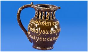 Slipware Puzzle Jug, with rhyme around the body ``Gentlemen come try your skill, I`ll hold your