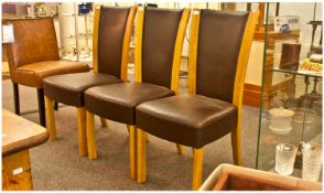 Set of Three Contemporary Dark Brown Leather Upholstered Dining Chairs, the backs with golden oak