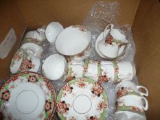 Box Containing a Late Victorian Tea Set, decorated in maroon and green floral foliage to borders.