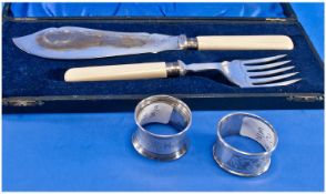 Pair Of Plated Fish Servers In Case with silver ferrels with two silver napkin rings.