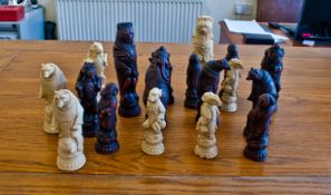 Set of Oriental Chess Pieces, in ivory coloured and mahogany coloured resin