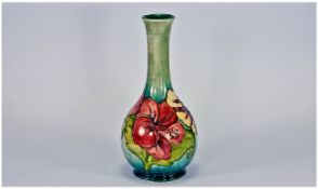 William Moorcroft Vase `Hibiscus` Design, on pale blue ground. Label to base. Reads `Potters to the