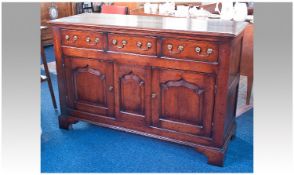 George II Style Oak Sideboard, fitted with three drawers over two doors, the doors with raised and